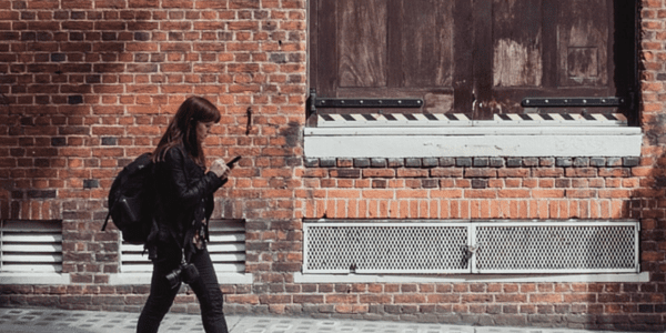 Young woman walking down a street