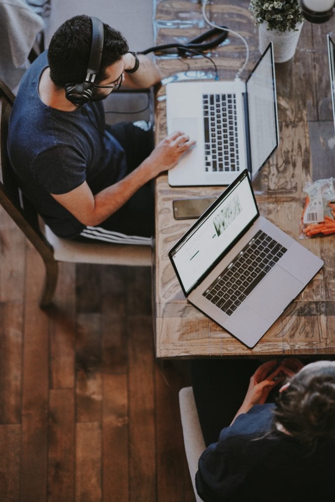 Man with headphones working on laptop